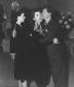 Mickey kisses Ann for her 21st birthday party as Judy Garland looks on